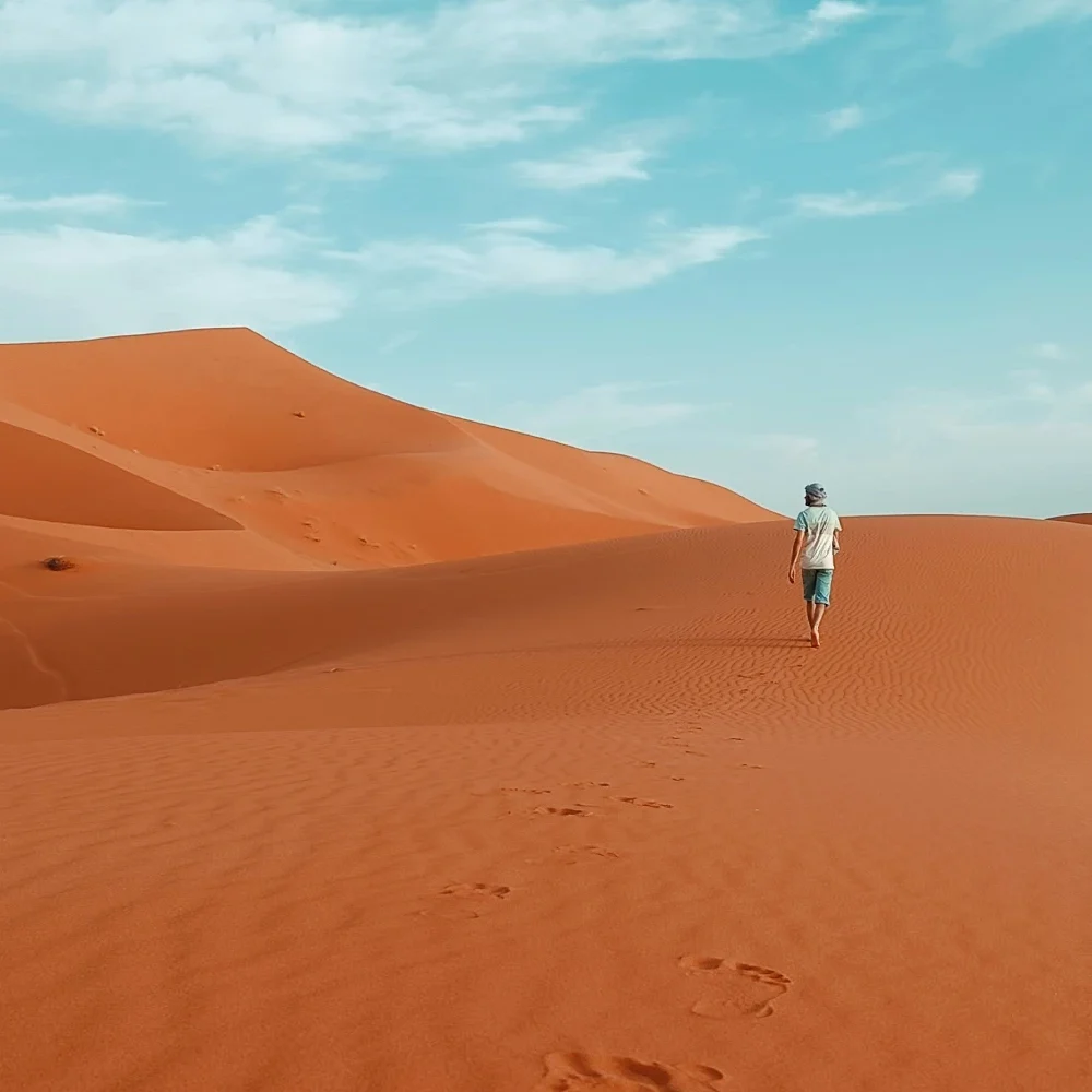 VoyageMorocco Traveler walks in the Merzouga Dunes