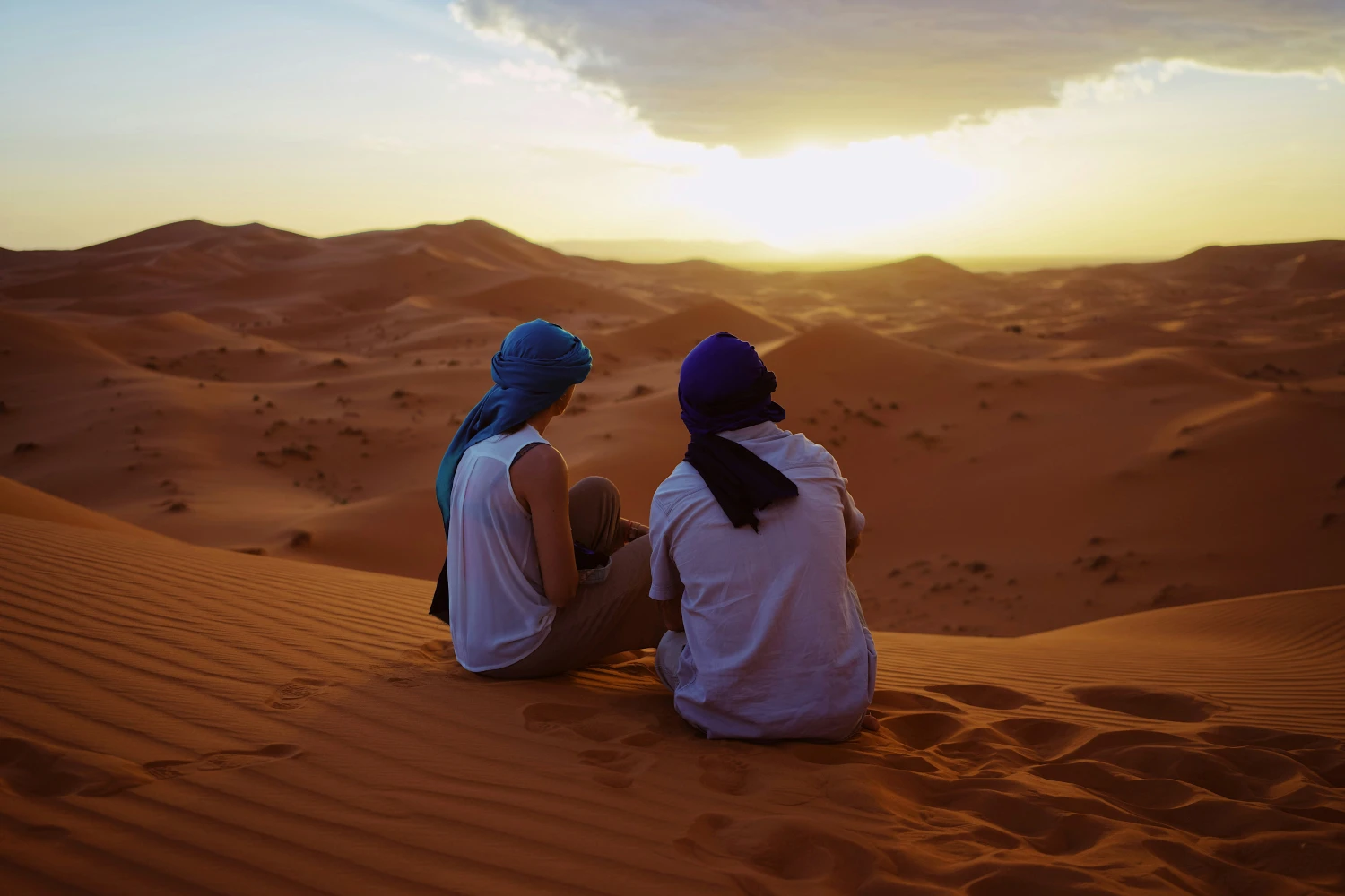 Couple enjoy the sunset of Merzouga Desert