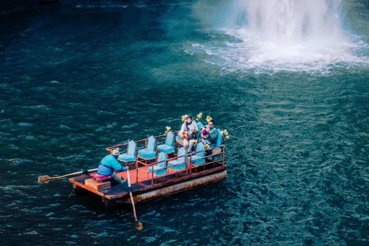 Travelers Enjoy the Boat Ride in Ouzoud Waterfalls