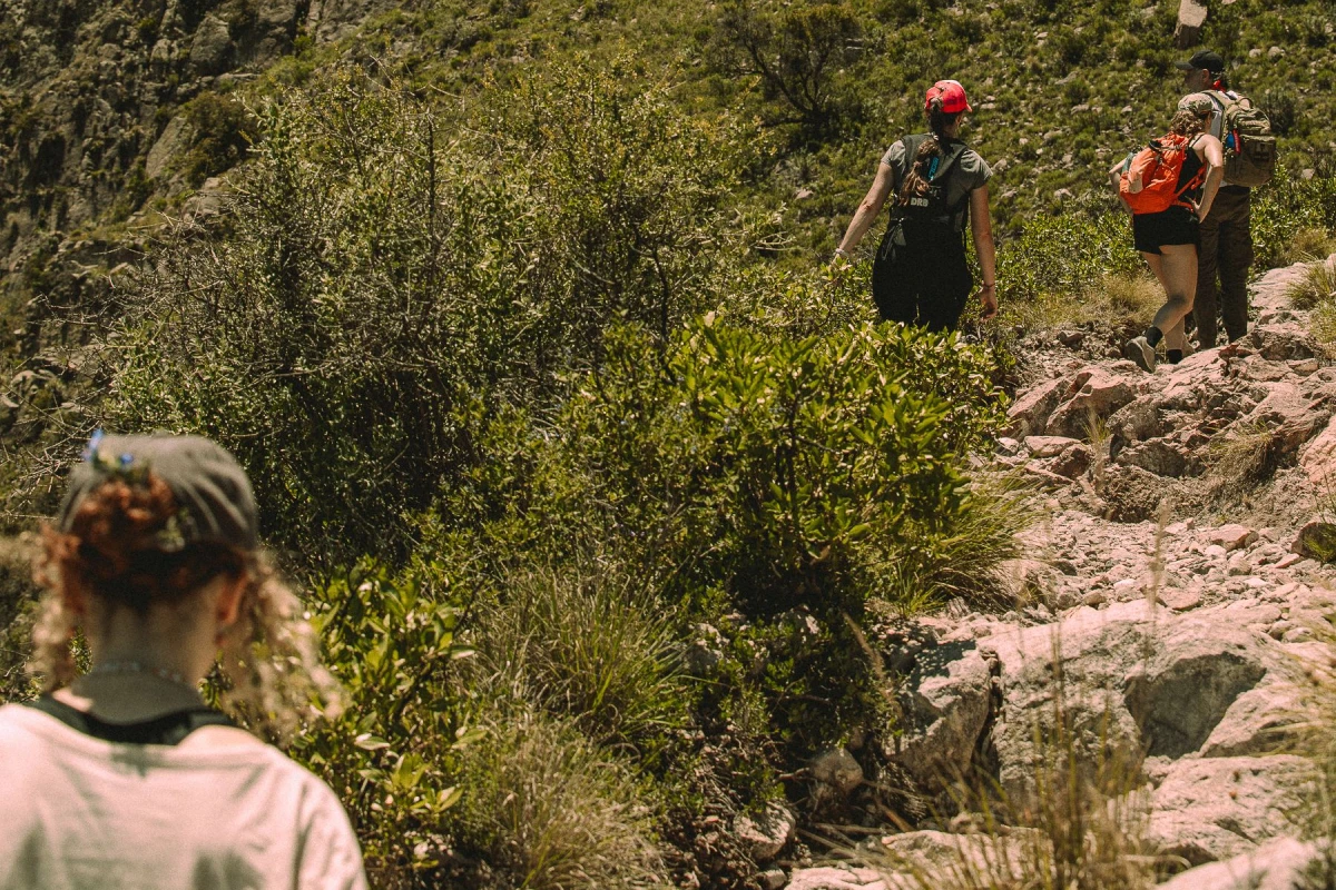 Travelers Hike in Mountains