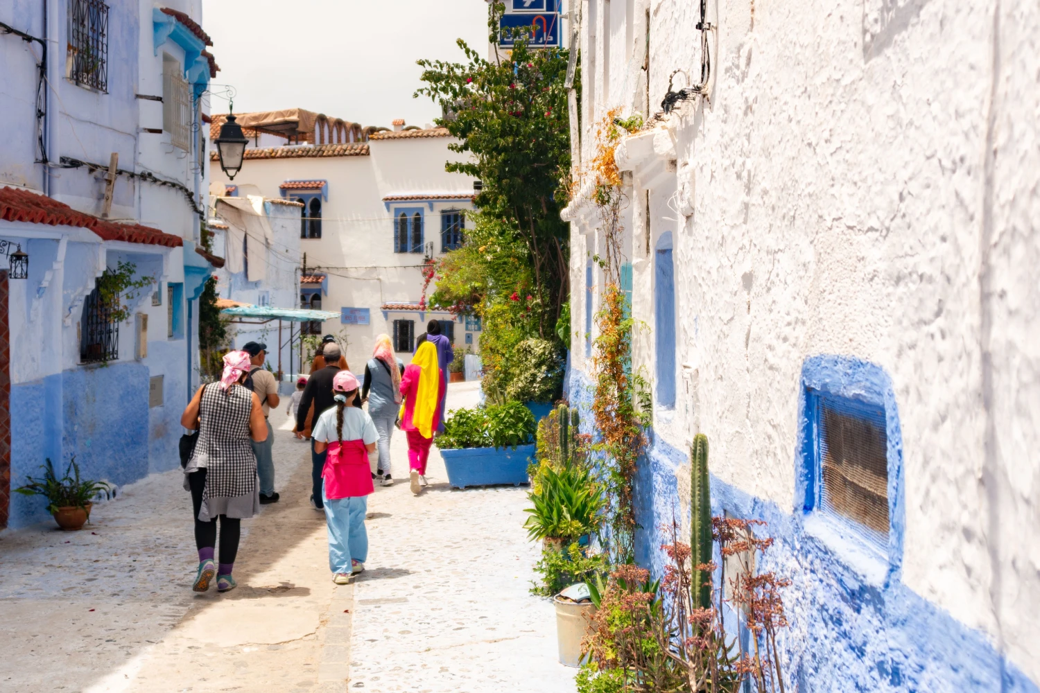 Travelers walk in Chefchaouen old quarters